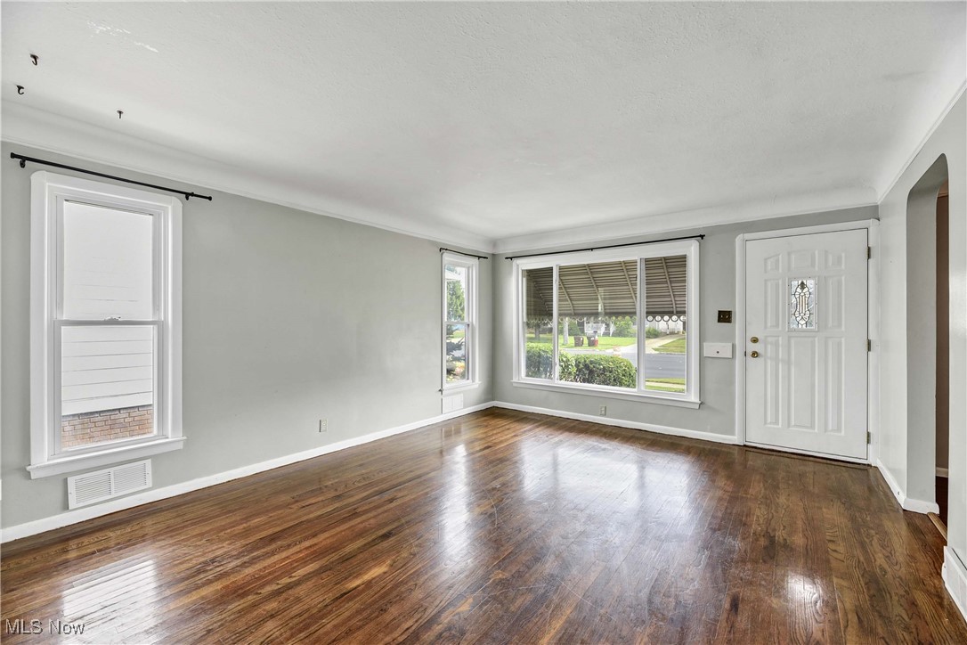 6506 Snow Road Parma, OH 44129 - Photo 11 of 25 Entryway featuring dark wood-style floors and crown molding