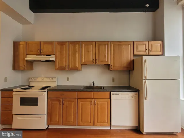 a kitchen with stainless steel appliances granite countertop a sink a stove and a microwave