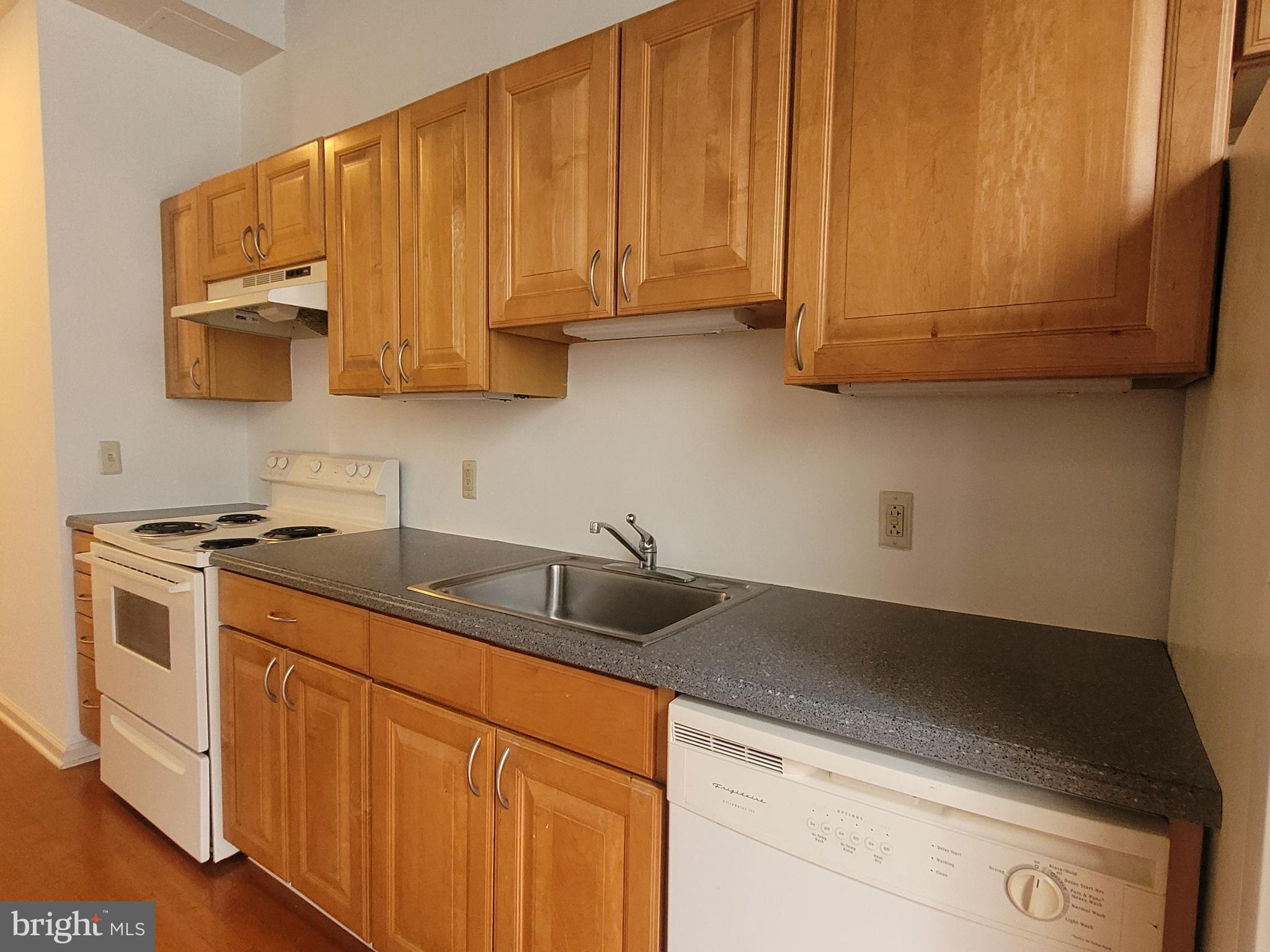 1427 Walnut Street, Unit 3F Philadelphia, PA 19102 - Photo 8 of 14 a kitchen with stainless steel appliances granite countertop a sink a stove and a microwave