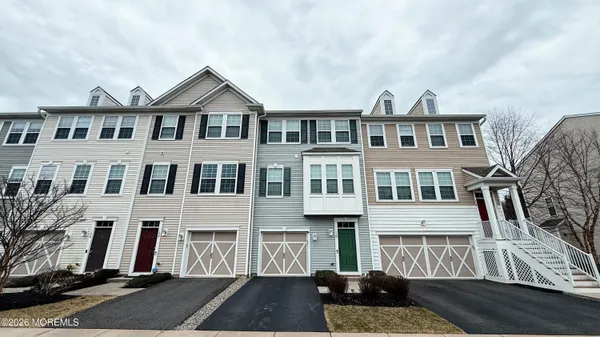 a living room with furniture a flat screen tv and a window