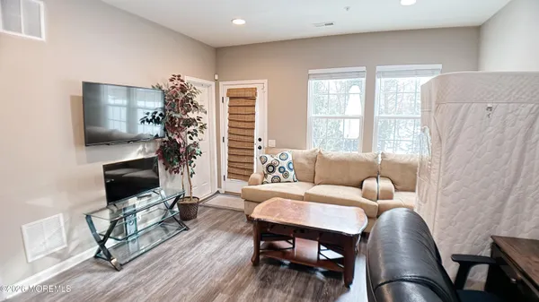 a living room with fireplace furniture and a wooden floor