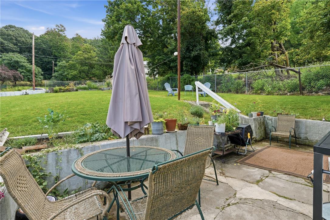 809 Hayes Street Bethlehem, PA 18015 - Photo 29 of 31 A stone patio overlooks an expansive green lawn surrounded by mature trees.