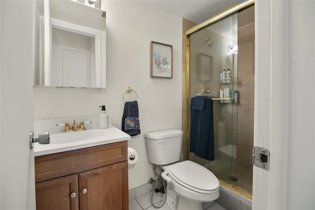 a bathroom with a toilet sink vanity and mirror