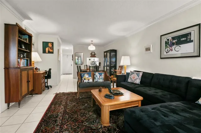 a living room with furniture a rug and a bookshelf