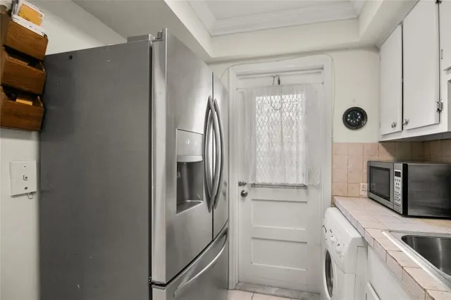 a kitchen with a refrigerator and microwave