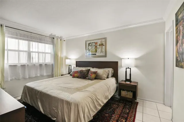 a bedroom with a bed and a night stand