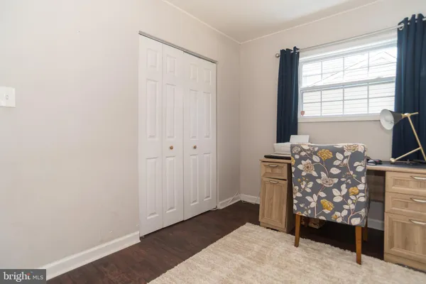 a view of a bedroom with workspace and a window
