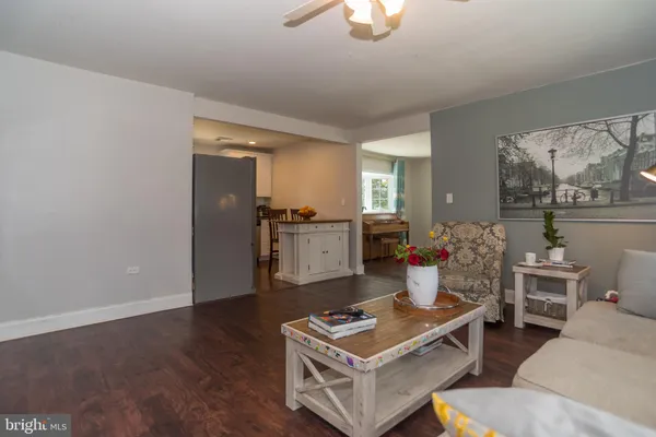 a living room with furniture and view of kitchen
