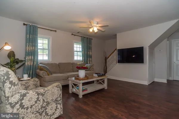 a living room with furniture and a flat screen tv