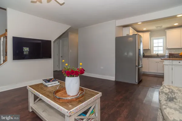 a kitchen with a refrigerator and a stove top oven