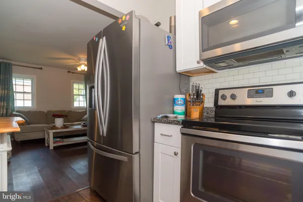 a kitchen with stainless steel appliances a refrigerator and a stove