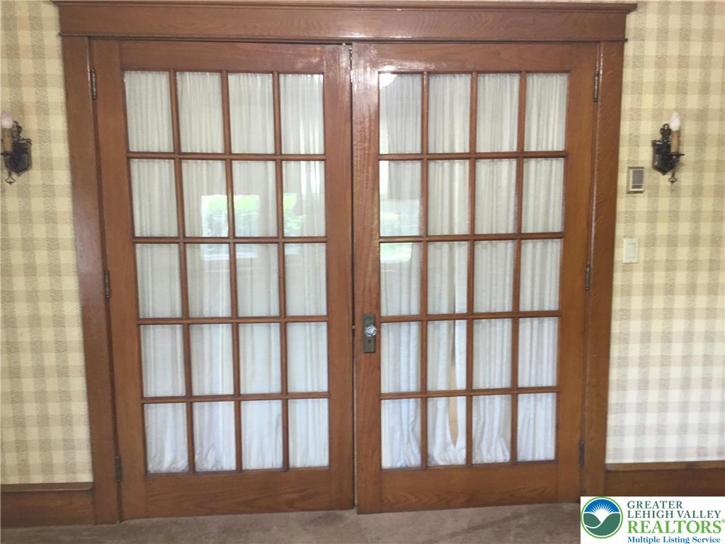 1105 Main Street Slatington, PA 18080 - Photo 8 of 31 French doors with grid panels open to a versatile interior space.