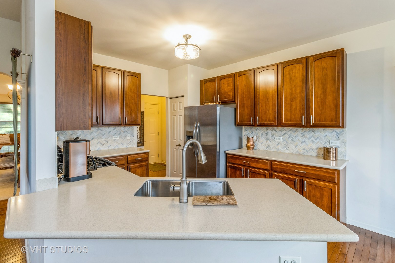 607 Waterford Road Elgin, IL 60124 - Photo 13 of 34 a kitchen with stainless steel appliances granite countertop a sink stove and refrigerator