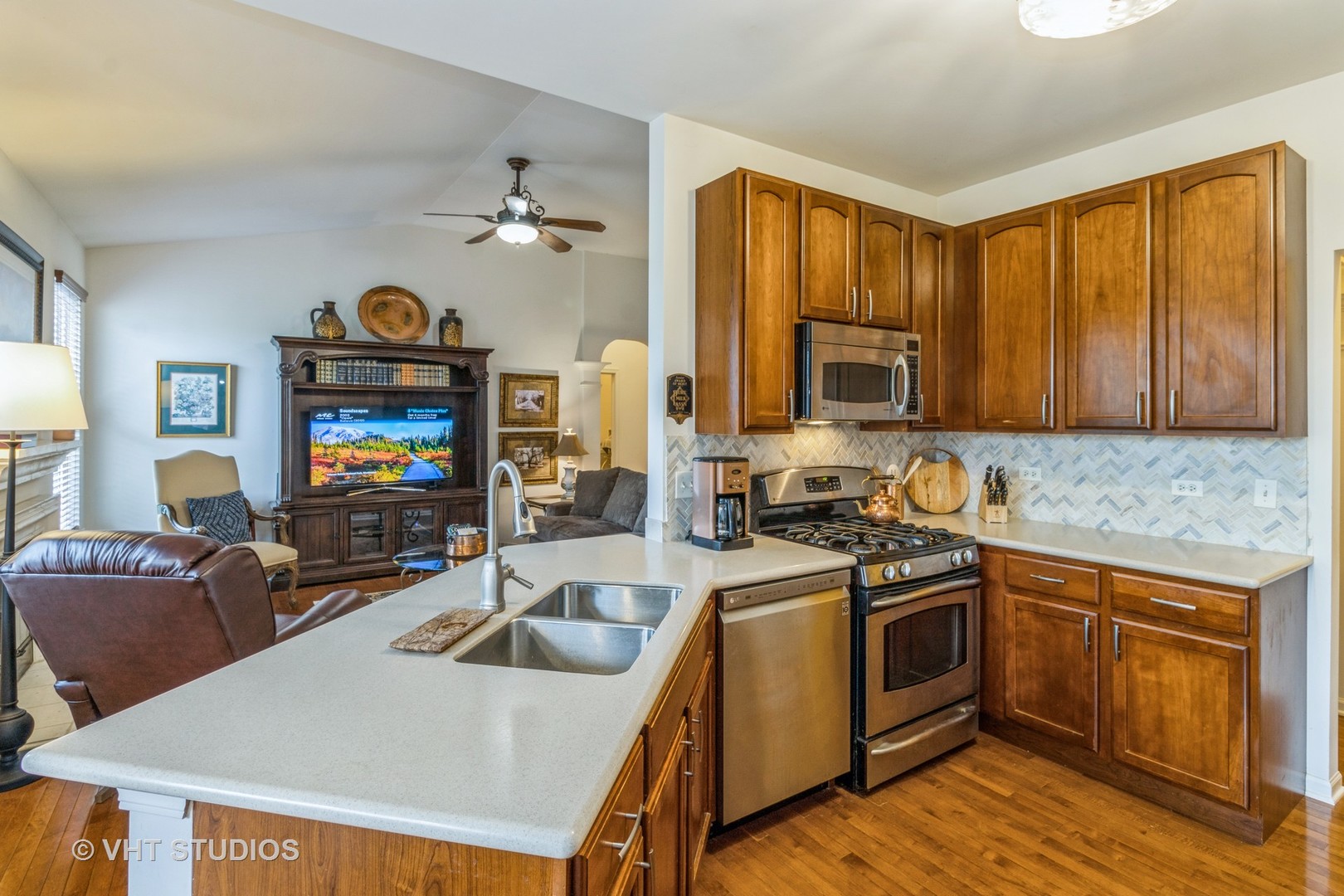 607 Waterford Road Elgin, IL 60124 - Photo 14 of 34 a kitchen with stainless steel appliances a stove a sink dishwasher a microwave oven with granite countertops and cabinets