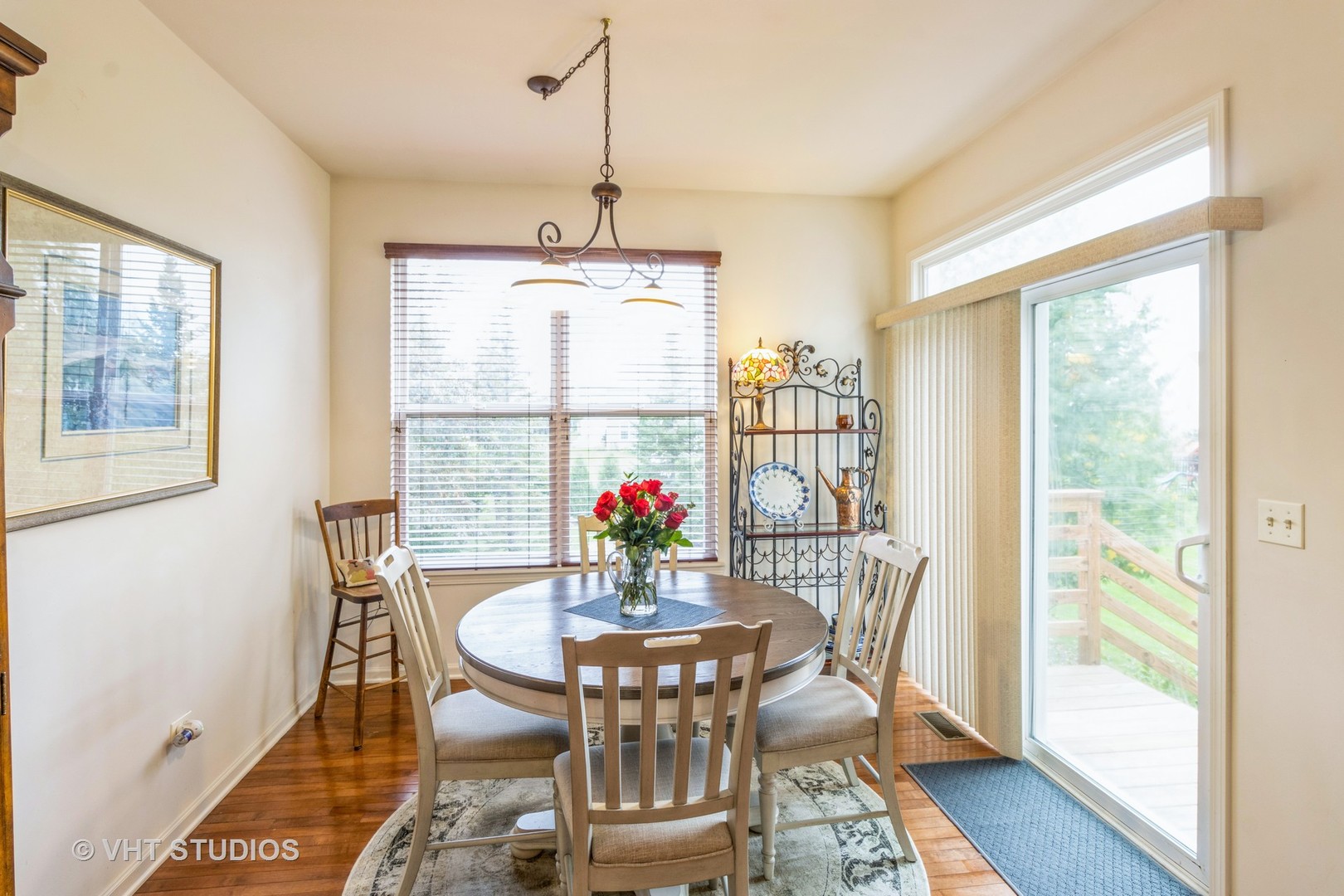 607 Waterford Road Elgin, IL 60124 - Photo 15 of 34 a view of a dining room with furniture a chandelier and wooden floor