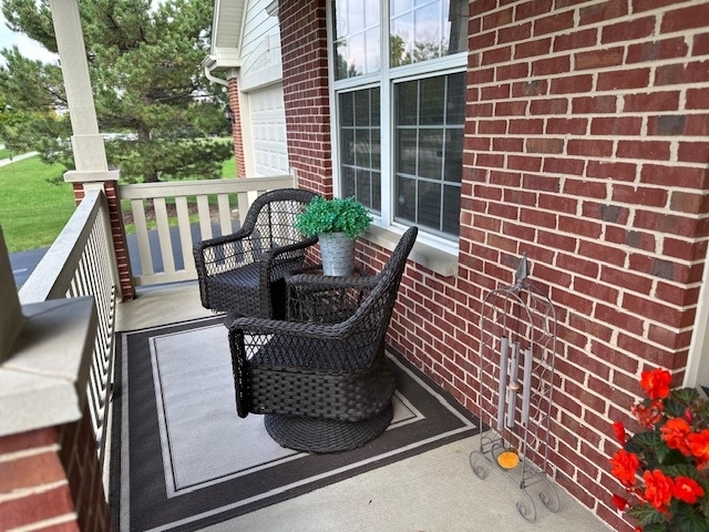 607 Waterford Road Elgin, IL 60124 - Photo 3 of 34 a view of balcony with two chairs and a potted plant