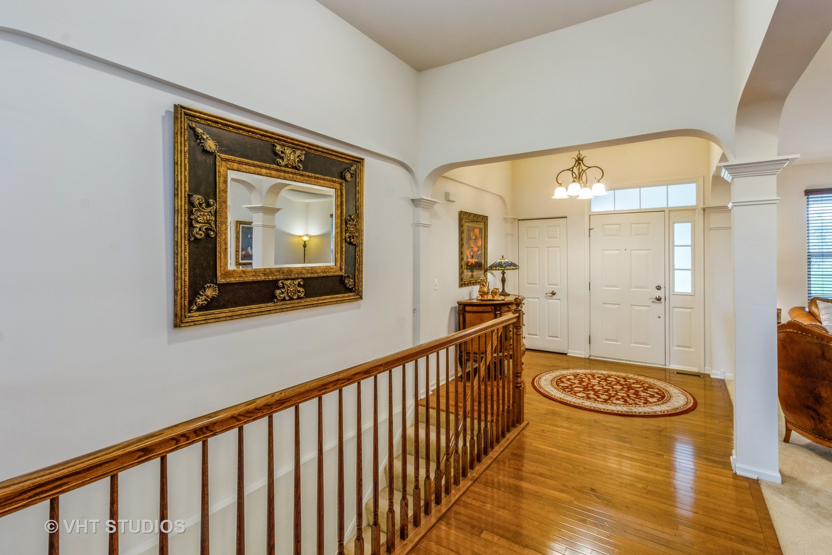607 Waterford Road Elgin, IL 60124 - Photo 5 of 34 a view of a hallway with wooden floor and furniture