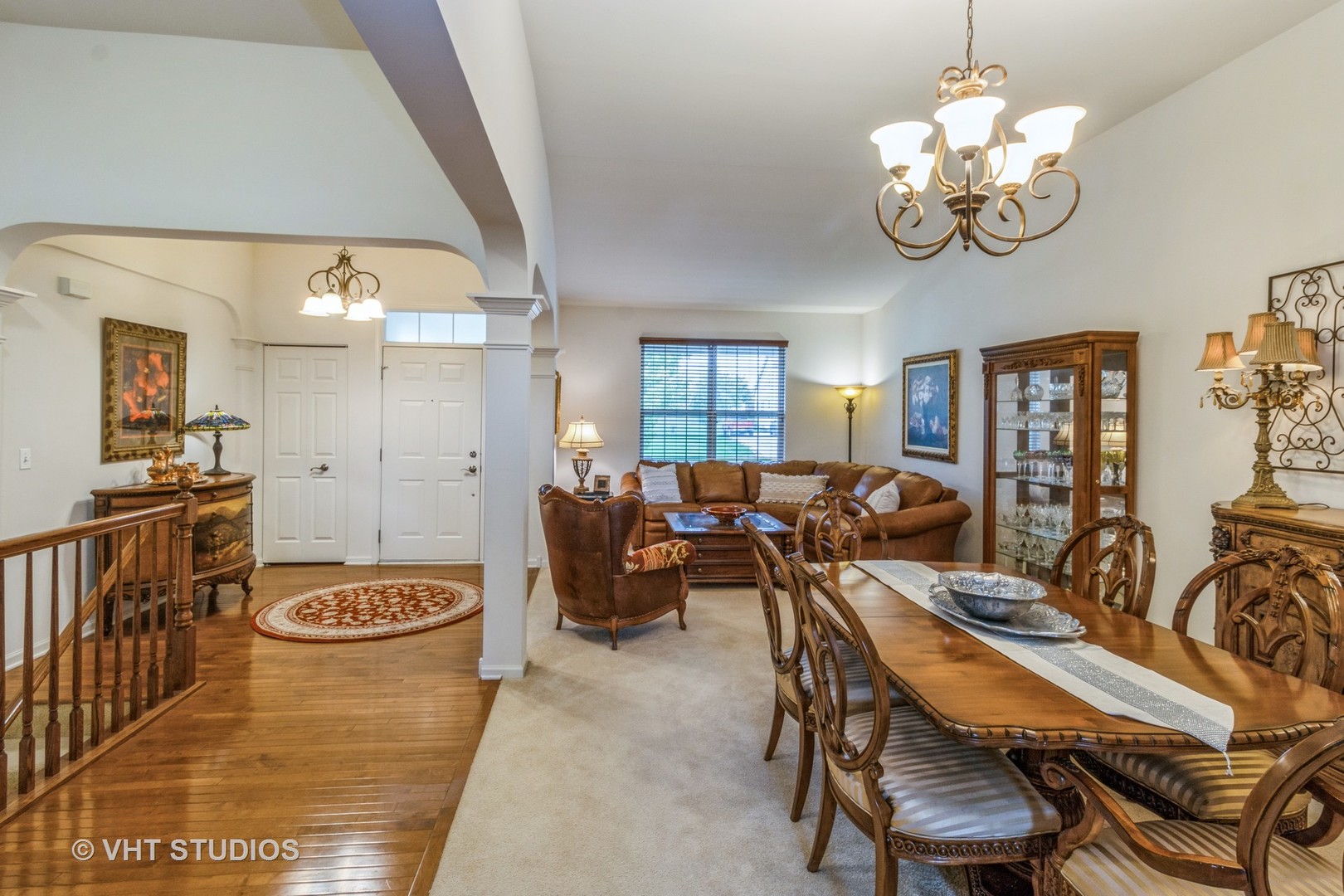 607 Waterford Road Elgin, IL 60124 - Photo 10 of 34 a view of a dining room and livingroom with furniture a rug a rug a fireplace and a chandelier