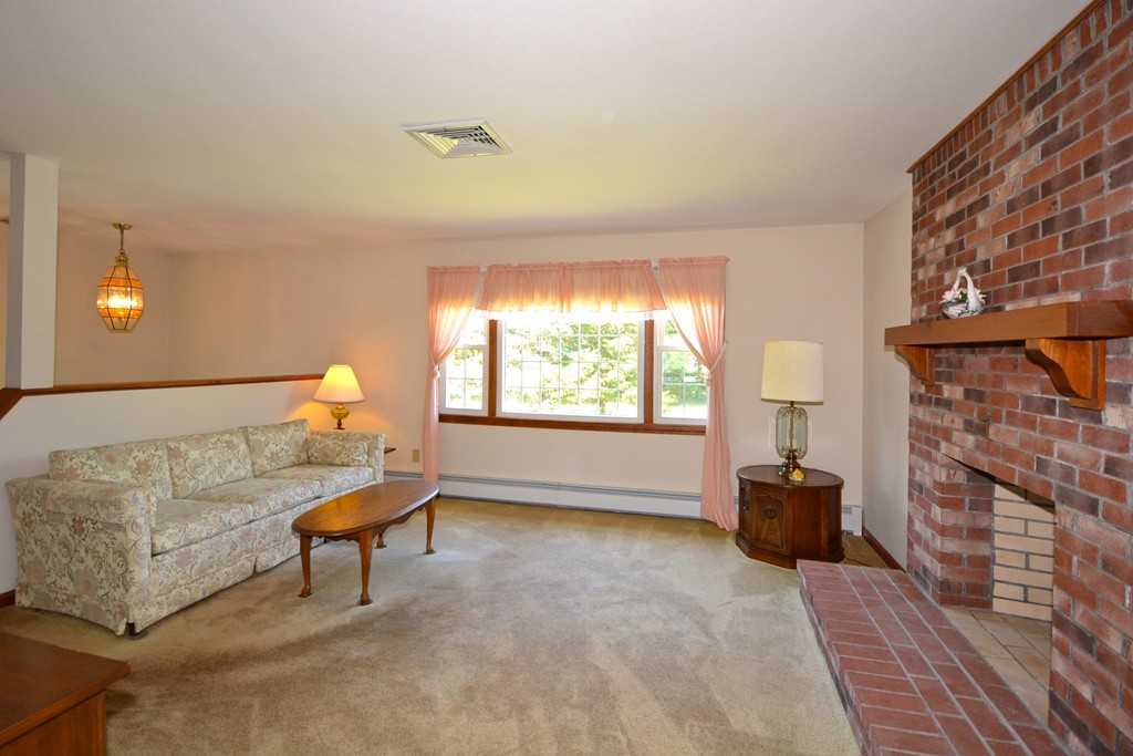722 Snipatuit Road Rochester, MA 02770 - Photo 4 of 15 a living room with furniture a window and a fireplace