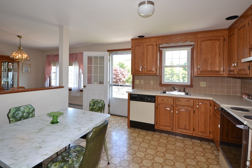 722 Snipatuit Road Rochester, MA 02770 - Photo 6 of 15 a kitchen with stainless steel appliances granite countertop wooden cabinets a stove a sink and a window