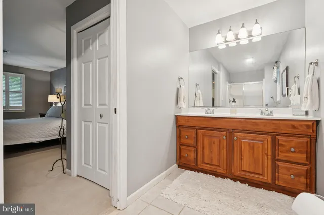 a living room with furniture a flat screen tv and a lamp