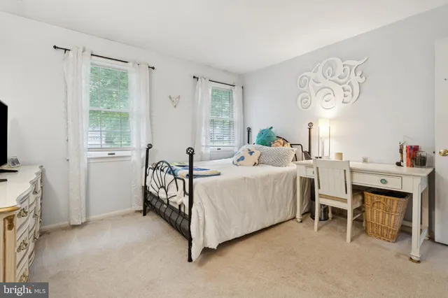 a living room with furniture gym equipment and a window