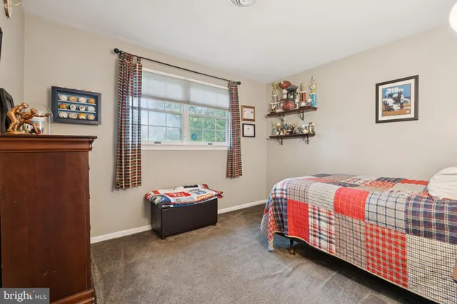 a view of a backyard with table and chairs potted plants and a large tree