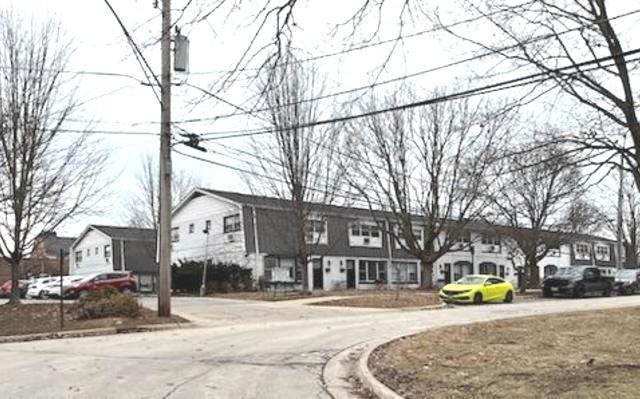 1900 Green Bay Road, Unit J Highland Park, IL 60035 - Photo 1 of 24 a view of a building with snow on the roadside
