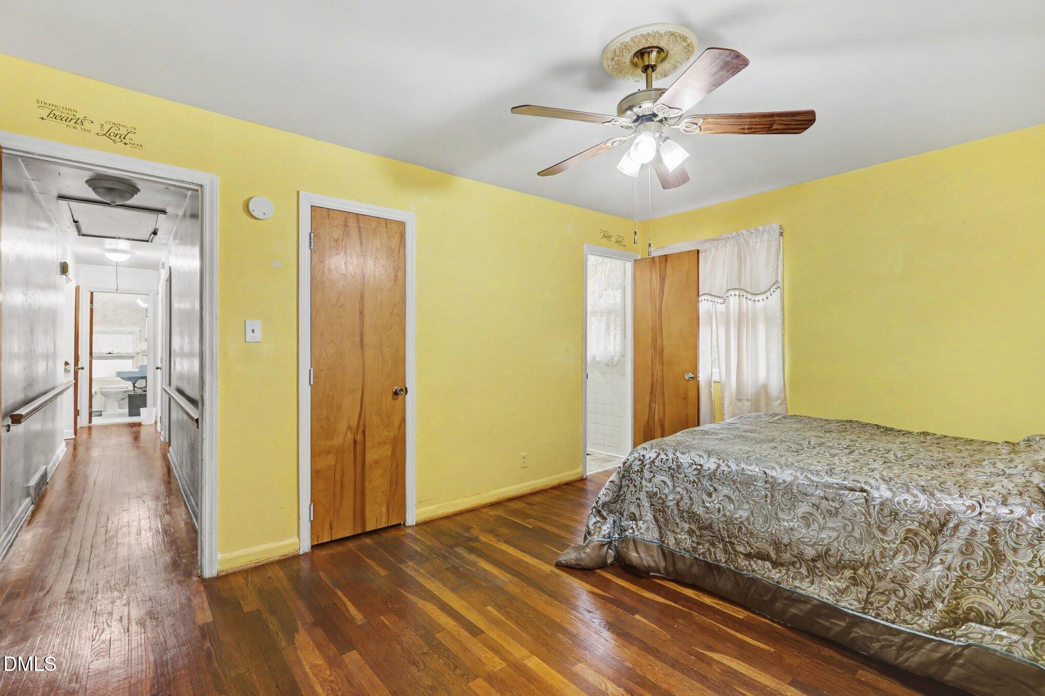 3719 Old Chapel Hill Road Durham, NC 27707 - Photo 12 of 33 a bedroom with a bed and a chandelier