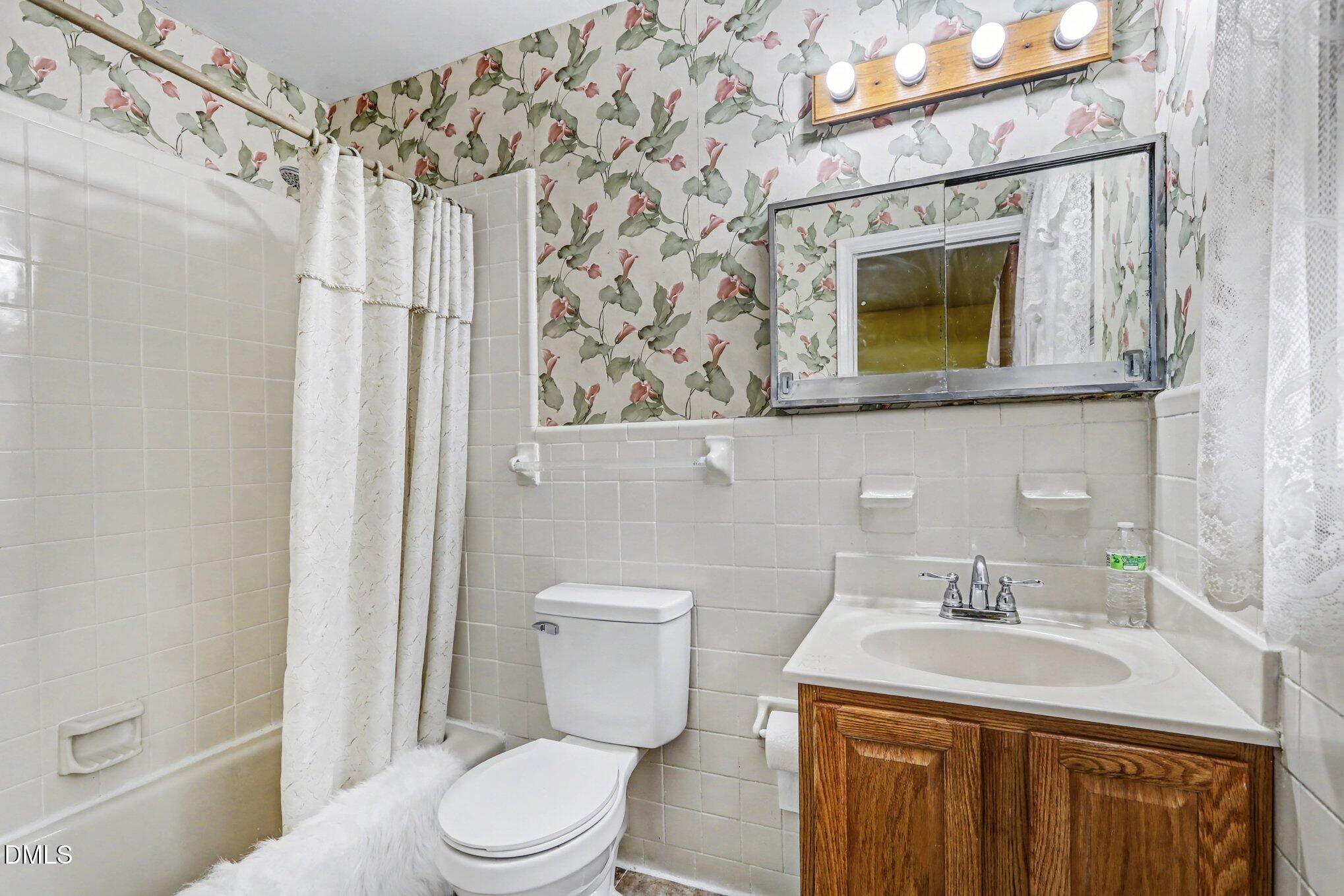 3719 Old Chapel Hill Road Durham, NC 27707 - Photo 13 of 33 a bathroom with a sink a toilet and shower curtain