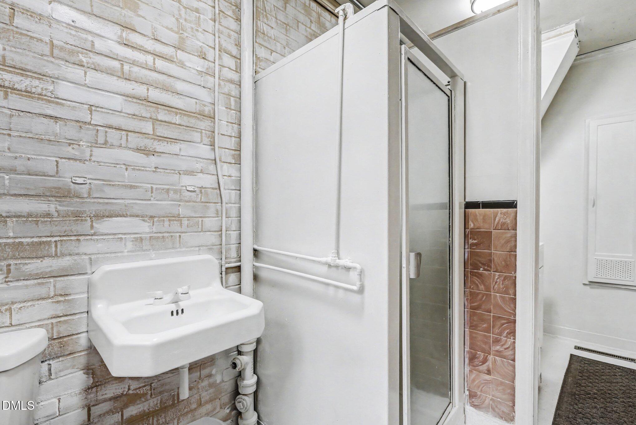 3719 Old Chapel Hill Road Durham, NC 27707 - Photo 20 of 33 a bathroom with a sink a toilet and shower