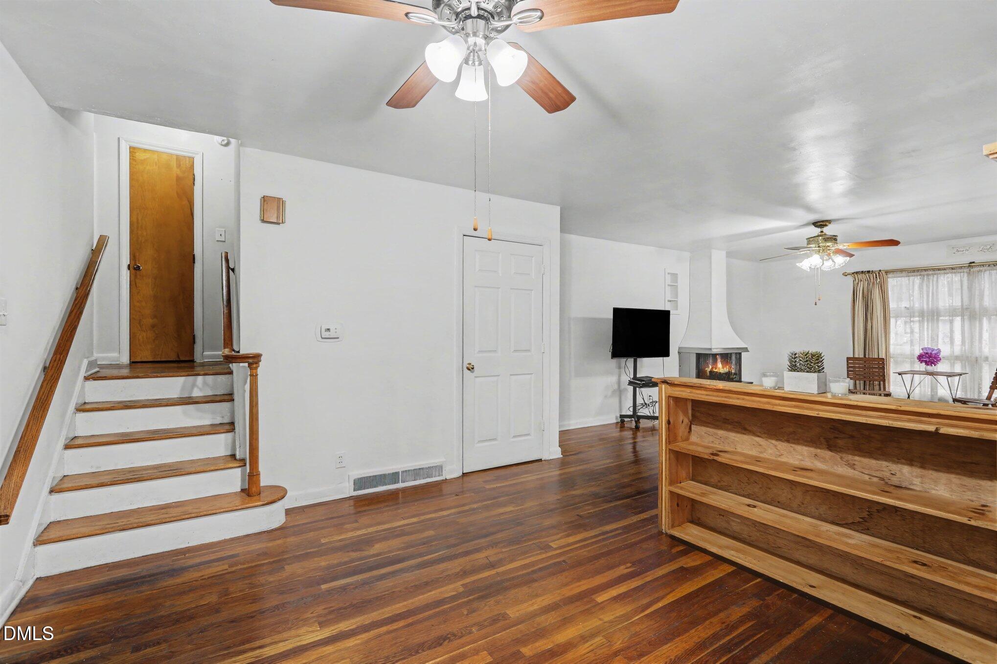 3719 Old Chapel Hill Road Durham, NC 27707 - Photo 5 of 33 a view of room with wooden floor and staircase