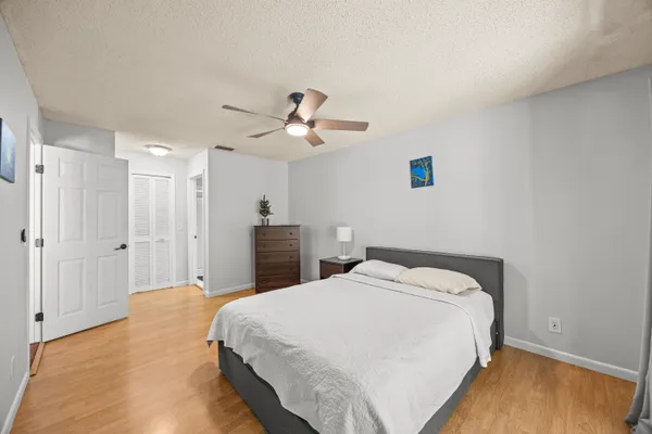 a spacious bedroom with a bed and a chandelier