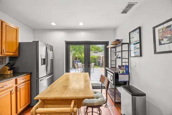 a kitchen with stainless steel appliances granite countertop a refrigerator and a stove top oven