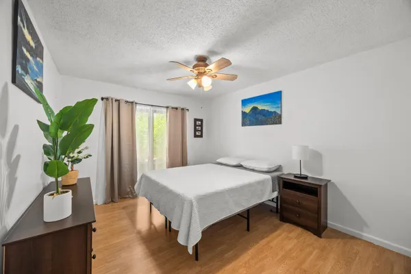 a bedroom with a bed and a chandelier