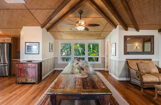a view of living room with furniture and large windows