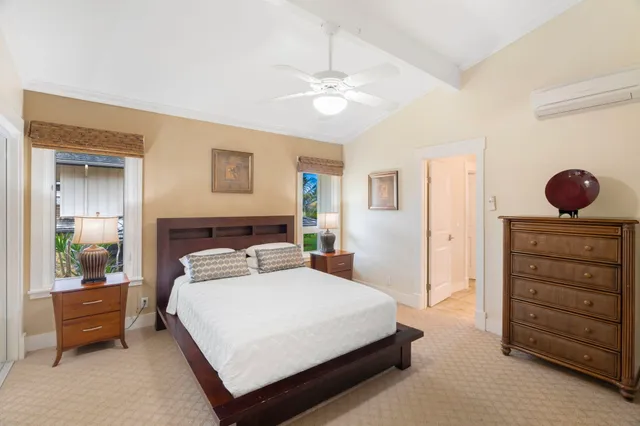 a bedroom with a large bed and a chandelier