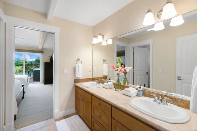 a bedroom with two beds and a chandelier