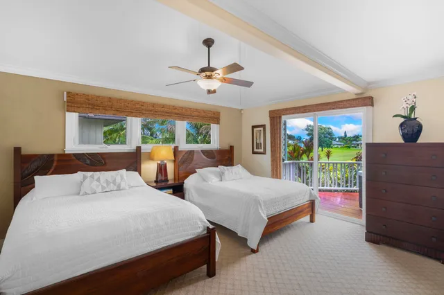 a bedroom with bed and glass windows