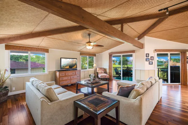 a living room with fireplace furniture and a wooden floor