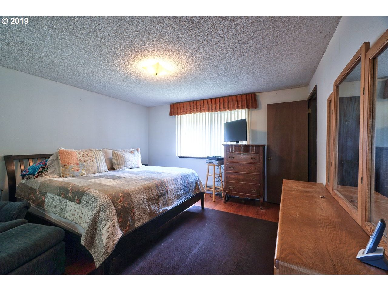 29081 Thistle Hill Road Rainier, OR 97048 - Photo 11 of 32 a bedroom with a bed and wooden floor