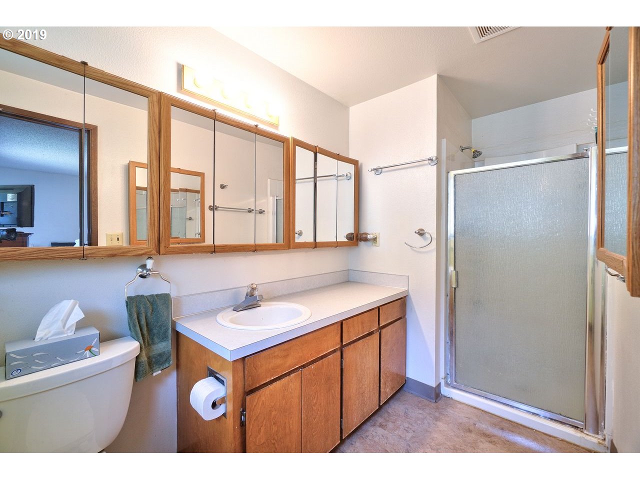 29081 Thistle Hill Road Rainier, OR 97048 - Photo 12 of 32 a bathroom with a sink a mirror and a shower