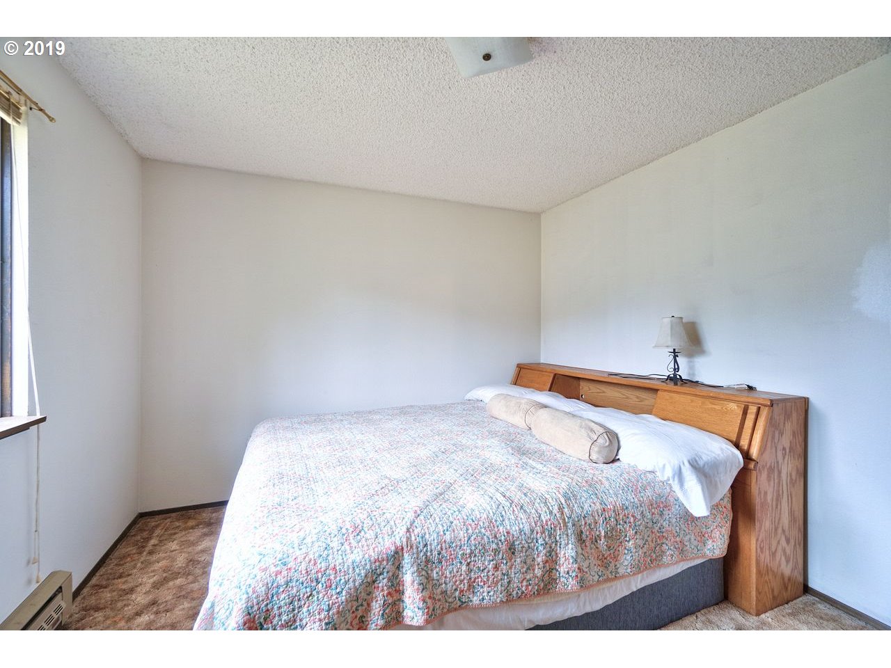 29081 Thistle Hill Road Rainier, OR 97048 - Photo 13 of 32 a bedroom with a bed and a night stand