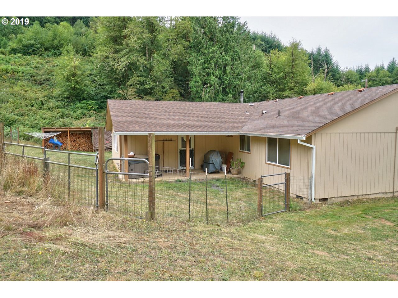 29081 Thistle Hill Road Rainier, OR 97048 - Photo 17 of 32 a view of a house with backyard porch and sitting area