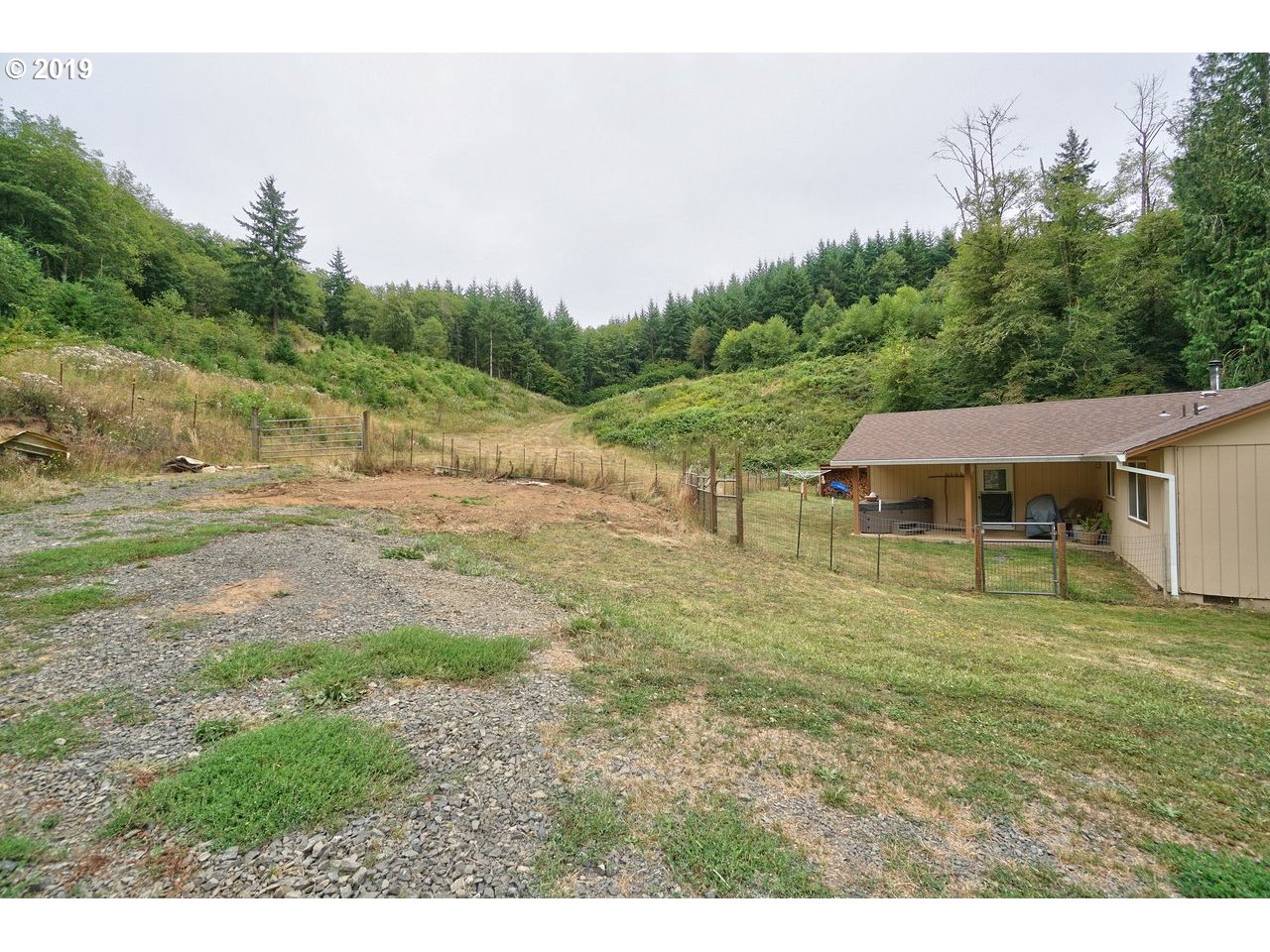 29081 Thistle Hill Road Rainier, OR 97048 - Photo 18 of 32 a view of a house with a yard