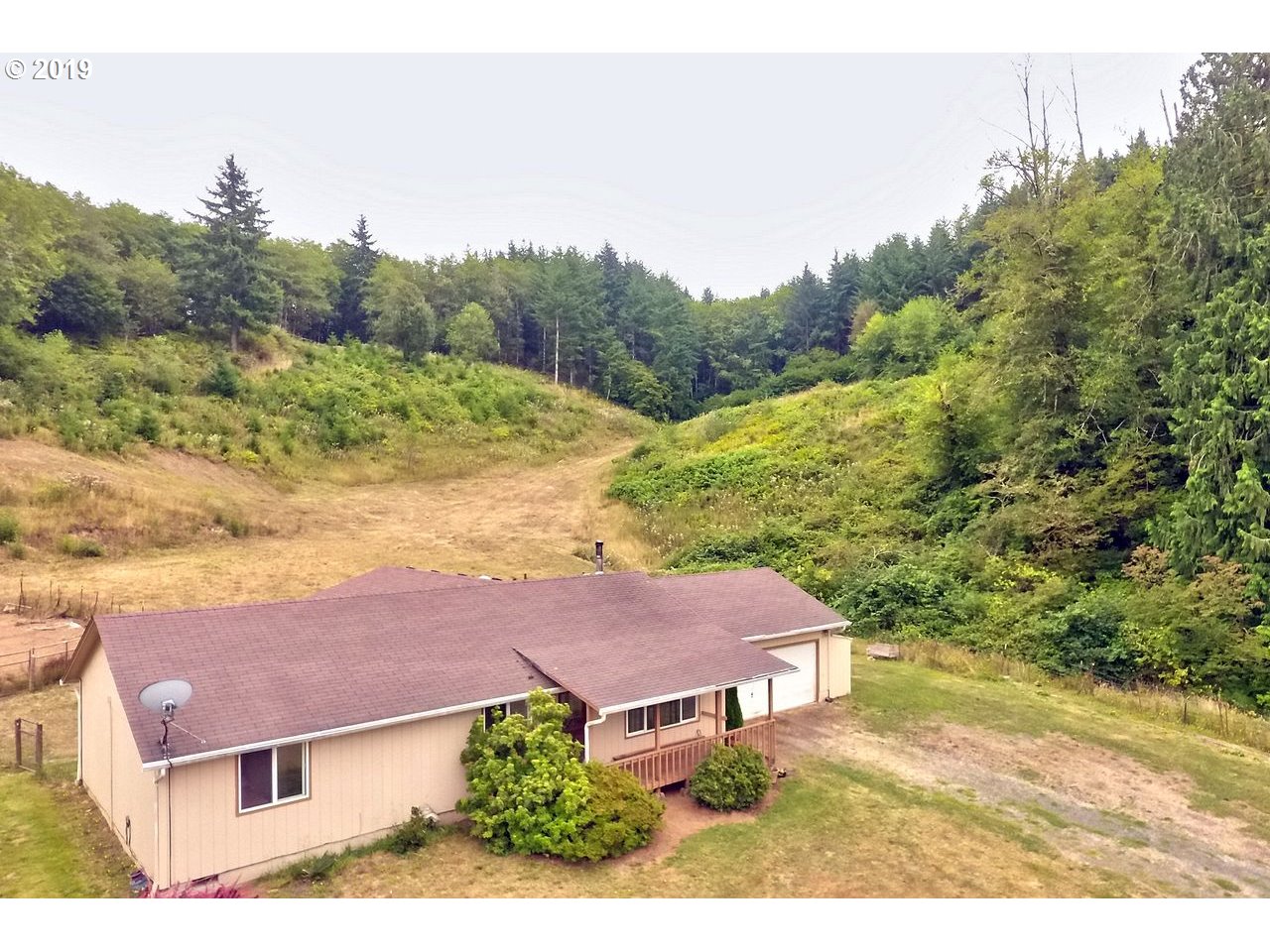 29081 Thistle Hill Road Rainier, OR 97048 - Photo 2 of 32 a view of a house with a yard