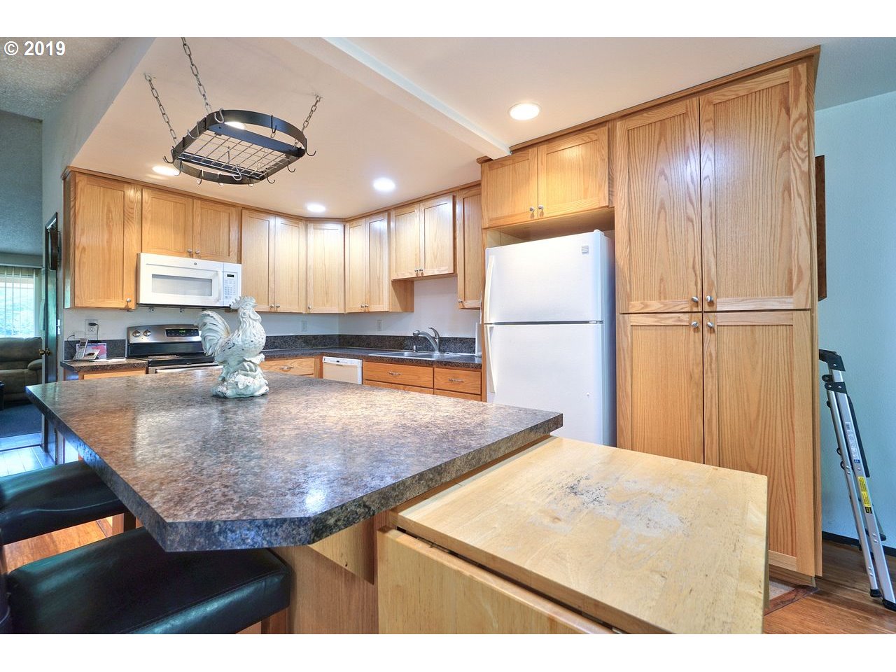 29081 Thistle Hill Road Rainier, OR 97048 - Photo 5 of 32 a kitchen with stainless steel appliances granite countertop a sink a refrigerator and a stove
