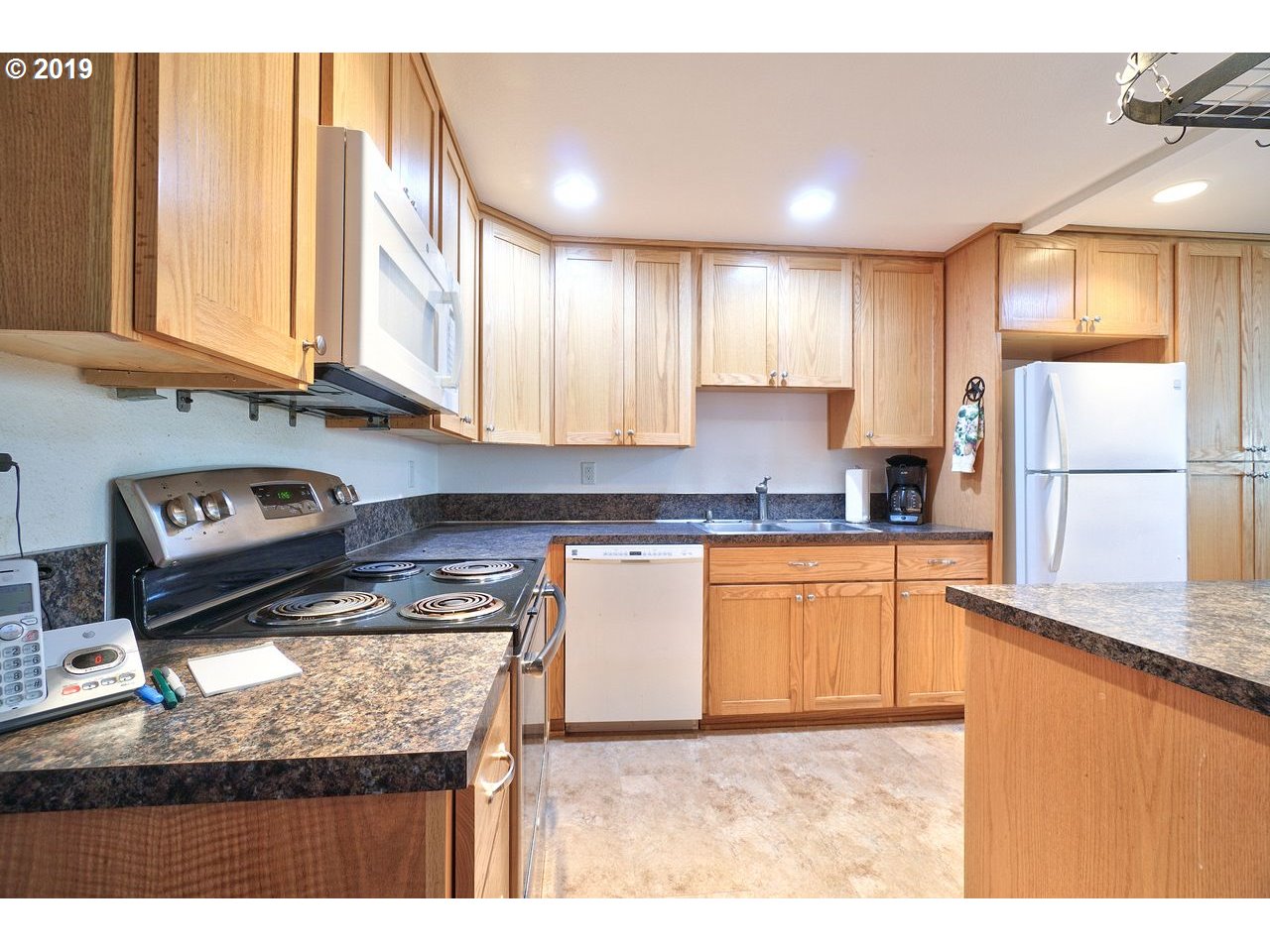 29081 Thistle Hill Road Rainier, OR 97048 - Photo 6 of 32 a kitchen with stainless steel appliances granite countertop a stove a sink dishwasher and a refrigerator