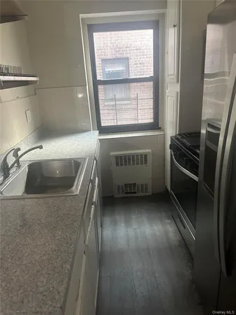 a kitchen with a refrigerator and a sink