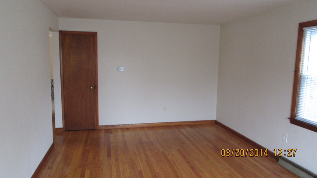 178 Redlands Street Springfield, MA 01104 - Photo 17 of 23 an empty room with wooden floor and windows